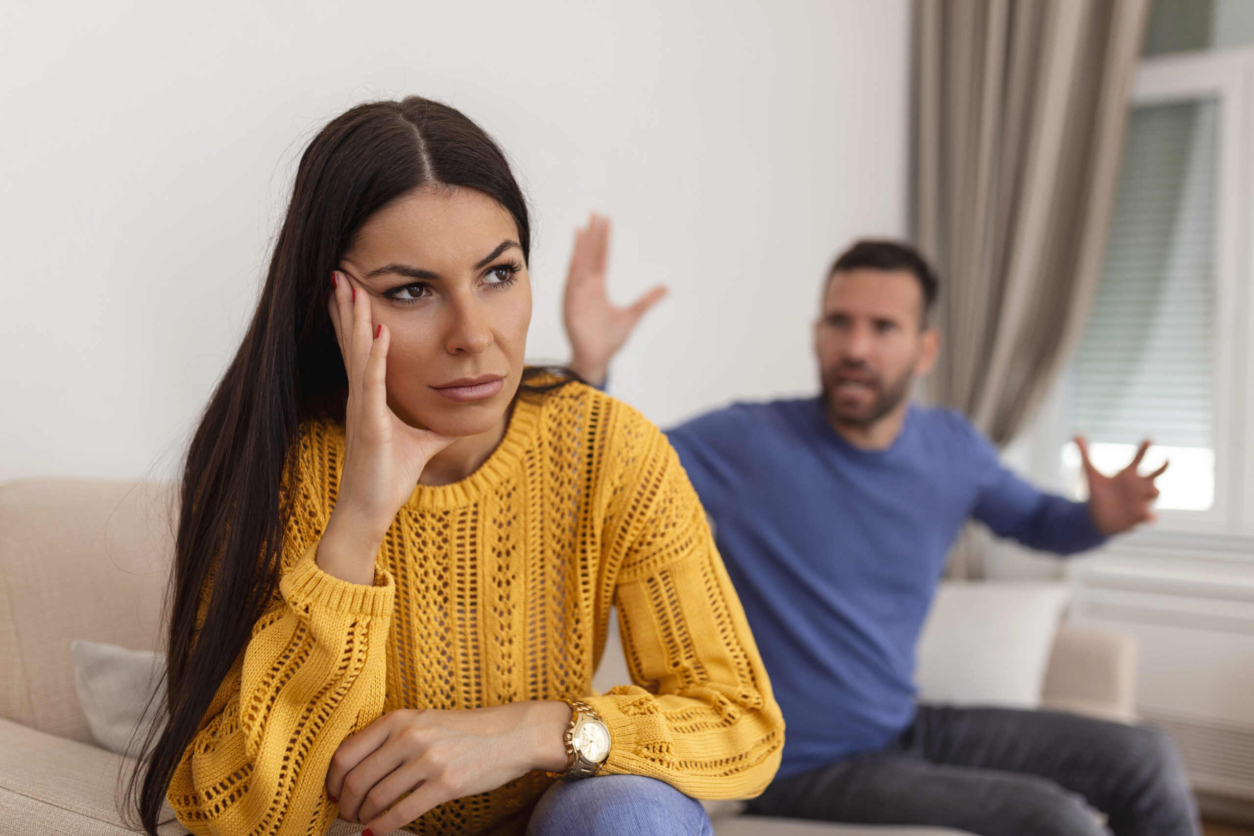 Young couple having argument conflict, bad relationships. Angry fury woman. Angry young couple sit on couch in living room having family fight or quarrel suffer from misunderstanding